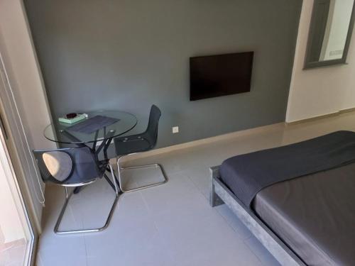 Schlafzimmer mit einem Bett und einem Tisch mit einem Laptop in der Unterkunft Modern Studio apartment Armonia Court in Paralimni