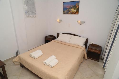 a bedroom with a bed with two towels on it at Joanna Apartments in Mikri Vigla