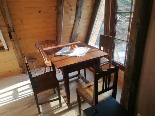 a wooden table and chairs in a room with a window at Ranch at Geta in Razgorce