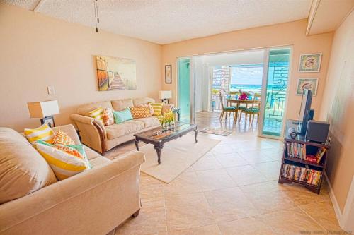 a living room with a couch and a table at Gorgeous Ocean Views! Welcome to Bella Breeze! BeachFront 2BR 2BA in Sion Farm