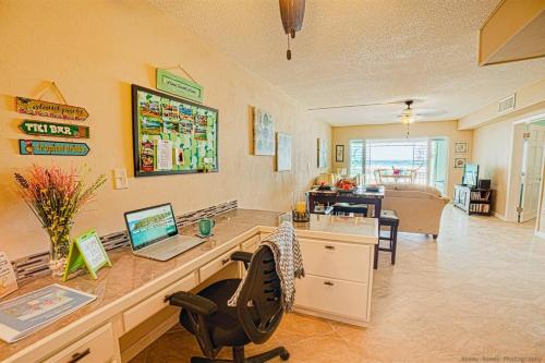 a office with a desk with a laptop computer on it at Gorgeous Ocean Views! Welcome to Bella Breeze! BeachFront 2BR 2BA in Sion Farm