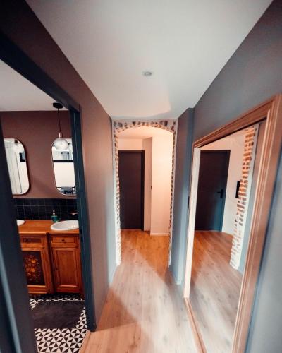 a bathroom with a sink and a mirror at La Petite Bélérit, maison de ville - Landerneau in Landerneau