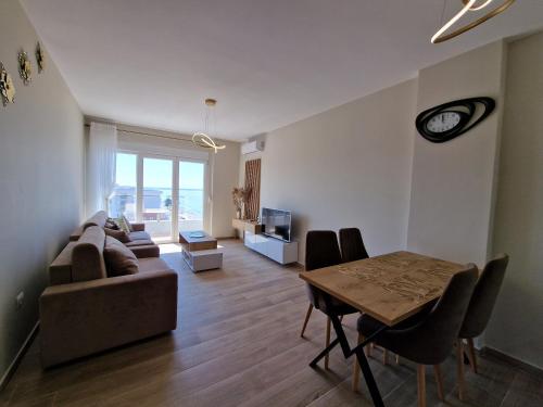 a living room with a table and a couch at Anchor Apartments in Shëngjin