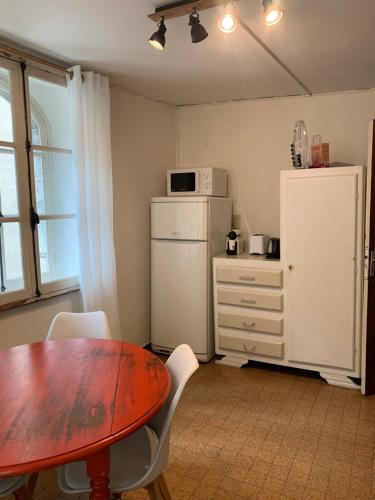 a kitchen with a table and a white refrigerator at Colmars les Alpes in Colmars