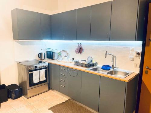 a small kitchen with a sink and a stove at Aegina luxury apartments in Aegina Town