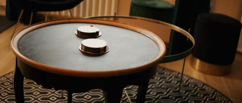 a table with two hats sitting on top of it at La Petite Bélérit, maison de ville - Landerneau in Landerneau