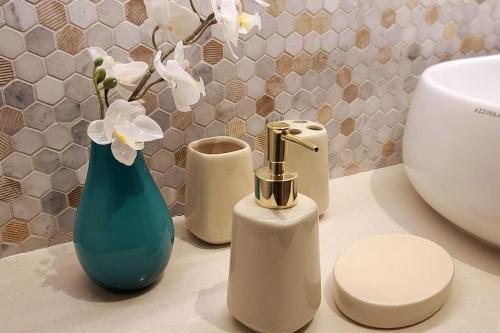a bathroom counter with a vase with flowers in it at Luxury apartment in Yas Island in Abu Dhabi