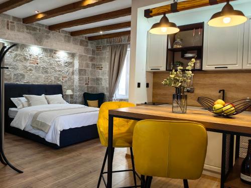 - une chambre avec un lit et une table avec des chaises jaunes dans l'établissement Apartments Lana Spalato, à Split