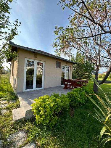 a small house with a picnic table in front of it at Christopher's apartments in Ulcinj