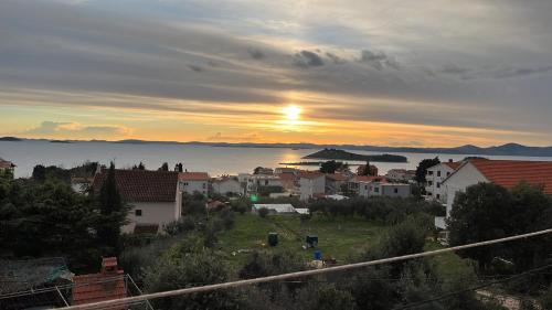 a view of a town with the sunset in the background at Francis Appartements in Pakoštane