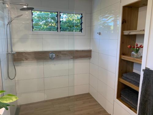 a bathroom with a shower and a window at Konini Retreat in Rarotonga