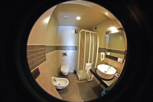 a bathroom with a sink and a shower and a toilet at Pisolo Resort in Sanremo