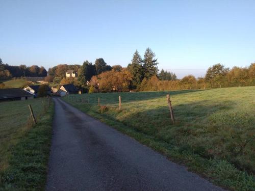 a dirt road in a field with a fence at Le Cosy in Sousceyrac