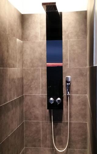 a shower with a hose in a bathroom at L'essens in Fayence