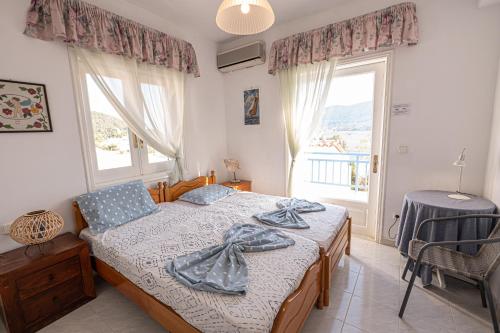 a bedroom with a bed and a large window at Rigos House at Askeli beach, Poros island in Poros