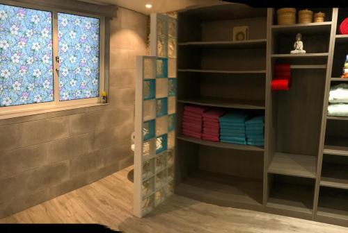 a room with a window and shelves with towels at Casa o Futuro in Alcobaça