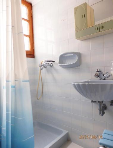 a bathroom with a sink and a shower at Maria's Studios in Skala Kallonis