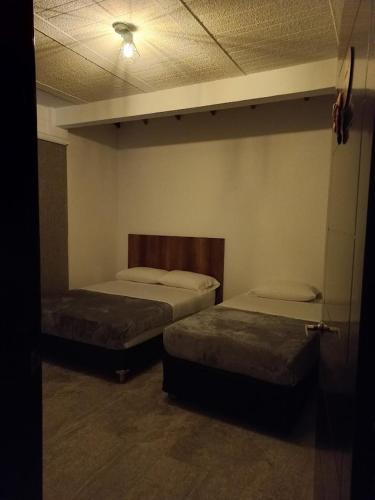 a room with two beds in a room with at Villa Paulina in Guadalupe
