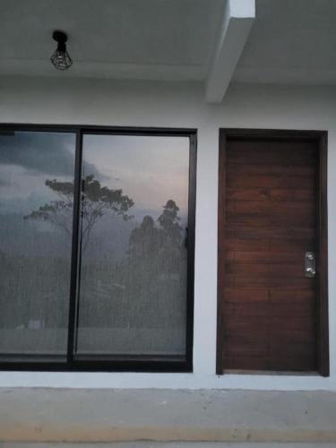 a room with two windows and a wooden door at Villa Paulina in Guadalupe