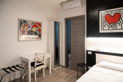 a bedroom with a desk and a bed and a table at Country Resort Modena in Modena