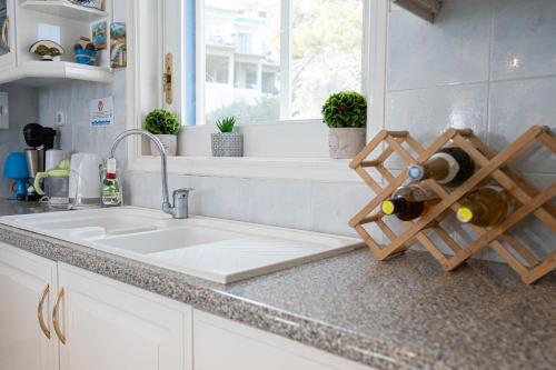 a kitchen counter with a sink and a window at Rigos House at Askeli beach, Poros island in Poros