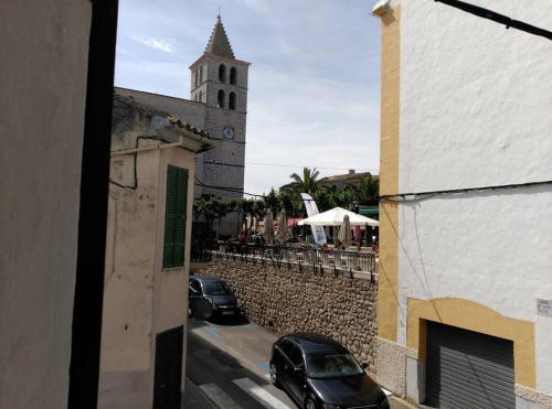 two cars parked on a street in front of a church at ANTIC ESTANC in Campanet