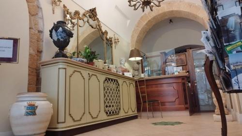 a room with a counter with vases on it at Hotel Akropolis - Museum Hotel in Taranto