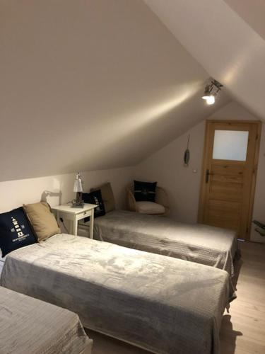 a bedroom with two beds in a room at Apartament Premium Łeba in Żarnowska