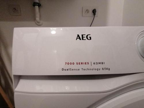 a bathroom with a asg sign on the top of a toilet at Bartine - modern and spacious flat near the sea, free parking space in Ostend