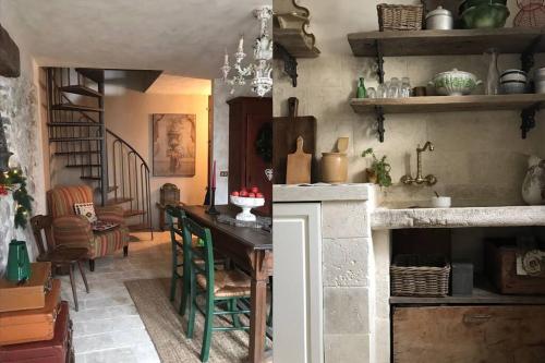 a kitchen with a table and a dining room at Borgo Ferracina by BORGHI VENETI in Solagna