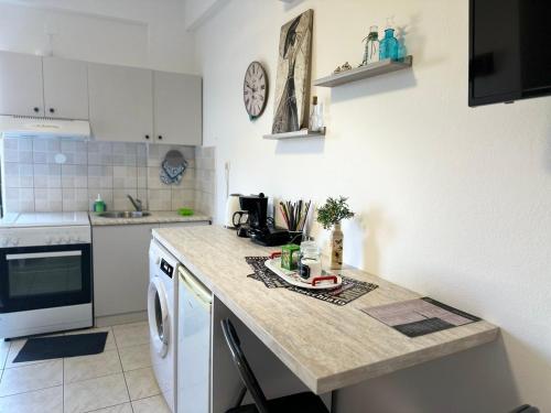 a kitchen with a counter and a dishwasher at M&M Modern Seaside Apartments Ammoudara Heraklion in Gázion