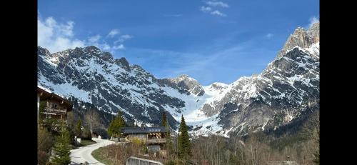 a snow covered mountain with a road in front of it at Alpenglück - Hinterthal in Hinterthal