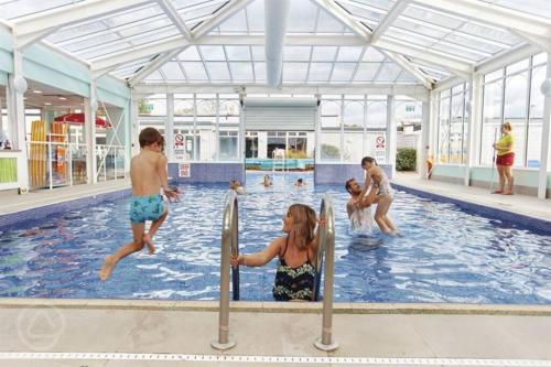 a group of children playing in a swimming pool at Sunny Hunny Manor Park Caravan in Hunstanton