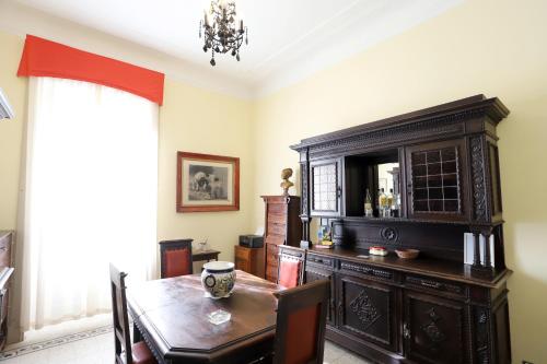 a dining room with a table and a large cabinet at La Villa del Lago in Ghirla