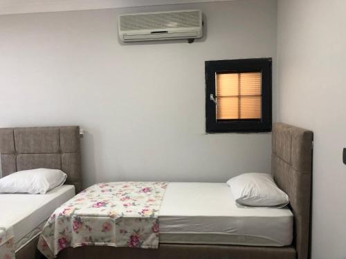 a bedroom with two beds and a air conditioner at seyran 3 in Trabzon
