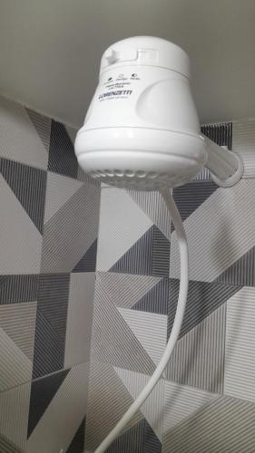 a white light hanging from a ceiling in a room at Loft 37 Centro histórico in Sao Paulo