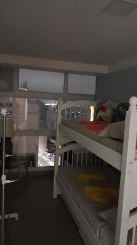 a bedroom with two bunk beds and a window at Loft 37 Centro histórico in Sao Paulo