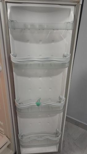 a refrigerator with empty shelves in a room at Loft 37 Centro histórico in Sao Paulo