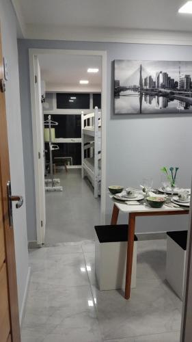a dining room with a table and a view of a living room at Loft 37 Centro histórico in Sao Paulo