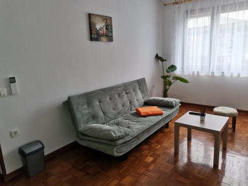 a living room with a couch and a table at Apartma David in Most na Soči