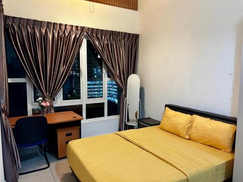 a bedroom with a bed and a desk and a window at Golden Sands Seaview Residence 3MIN walk to Hospital Sultanah Aminah by Micasa Homestay in Johor Bahru