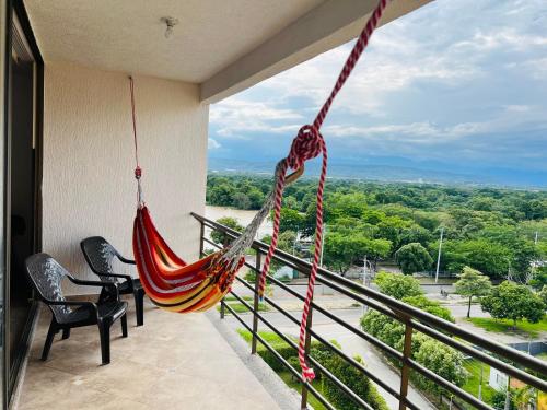 a hammock on a balcony with a view at Fresco, cómodo y Amplio! in Neiva