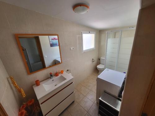 a bathroom with a sink and a mirror and a toilet at Casa rural cerca Tarancón-Cuenca in Saelices