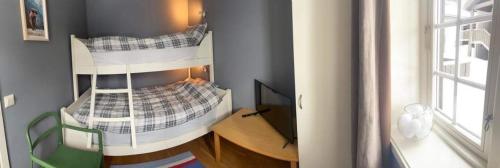 Cette chambre dispose de lits superposés, d'une table et d'une fenêtre. dans l'établissement Leilighet i Fageråsen i nærheten av Høyfjellssenteret med sengeplass for 4-7 personer, à Trysil
