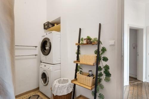 a laundry room with a washer and dryer at Cozy Antwerp - Sunny Zurenborg in Antwerp