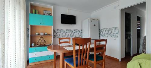 a dining room with a wooden table and chairs at Reus y MAr Salou in Salou