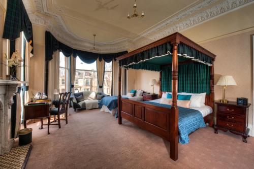 een slaapkamer met een hemelbed en een woonkamer bij Kildonan Lodge Hotel in Edinburgh