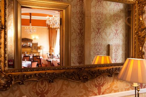 a mirror on the wall of a room at Kildonan Lodge Hotel in Edinburgh