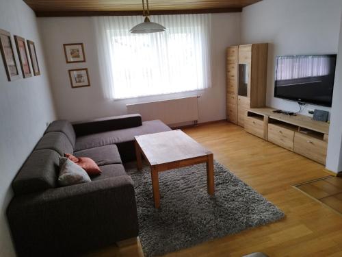 ein Wohnzimmer mit einem Sofa und einem Tisch in der Unterkunft Oma‘s Häuschen in Schwenningen