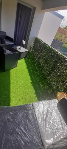 ein Wohnzimmer mit grünem Gras und einem Fenster in der Unterkunft T2 de Haut standing- Montpellier in Montpellier